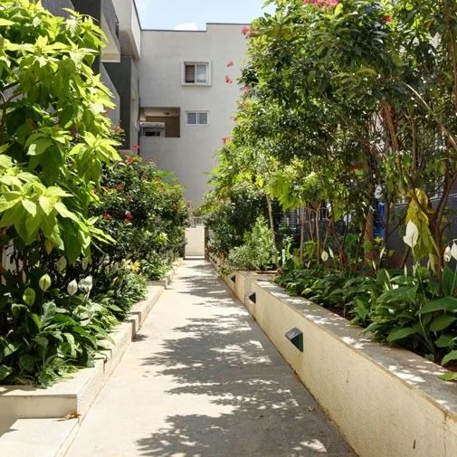 Vaishnavi Orchids, Sarjapur Road A shaded garden walk at Vaishnavi Orchids