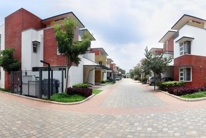 A tree-lined villa street at Vaishnavi Commune